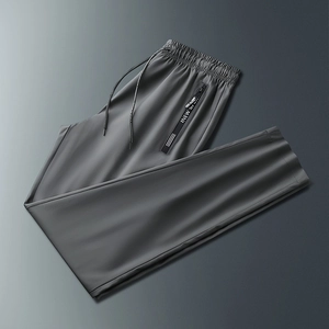 Detailed close-up of dark grey ice silk sports pants with zip pocket and elastic drawstring
