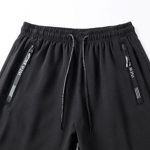 Detail of elastic waist with drawstring and zipper pocket on thin ice silk sports pants