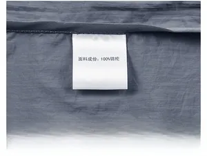 Macro shot of 100% nylon cooling fabric texture and wash care label on sun protection jacket