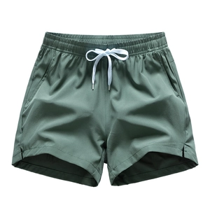 Men's loose dark green casual shorts with elastic waistband and white drawstring