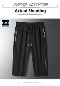 Detail view of black ice silk shorts with white typography print and elastic drawstring waist