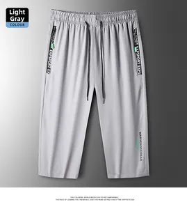 Detail of light grey ice silk sports shorts featuring zipper pockets and elastic drawstring