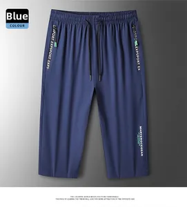 Detail view of blue ice silk shorts showing elastic drawstring waist and side zip pockets