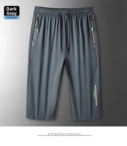 Detail of dark grey ice silk sport shorts with drawstring waist and side letter printing