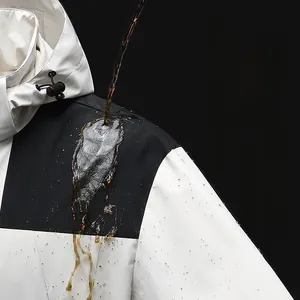 Detail of waterproof outdoor jacket fabric showing hydrophobic lotus effect water droplets