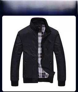 Detail of black stand collar jacket featuring classic plaid lining and zip pockets