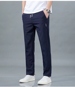 Détail du pantalon en soie glacée bleu marine avec cordon à la taille et étiquette de poche