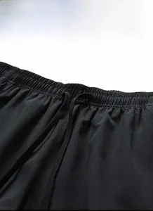 Detail of elastic waistband and adjustable flat drawstring on black casual shorts