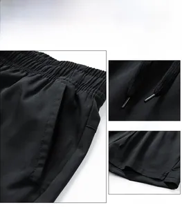 Detail of men's black shorts with elastic waistband, drawstring and side pocket