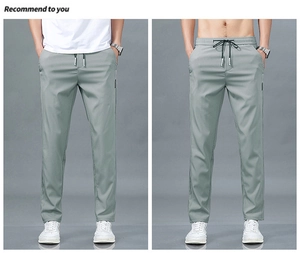Détail du pantalon en soie glacée vert sauge avec taille élastique à cordon et poches