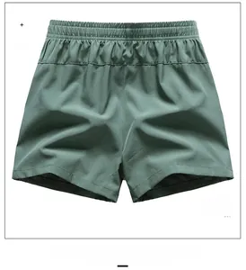 Rear view of men's dark green loose fit quick-dry sports shorts with elastic waist
