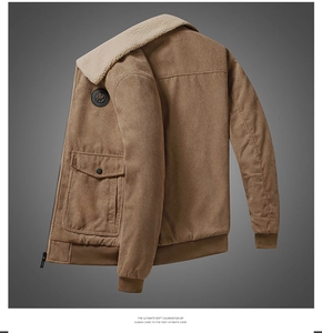 Detail of a brown corduroy jacket featuring a cream faux fur collar and ribbed cuffs