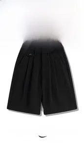 Detail of black quick-dry shorts featuring waist pleats and decorative pocket button