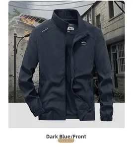 Detail of navy blue outdoor jacket featuring chest mountain logo and elastic cuffs