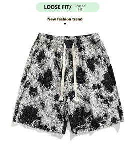 Close-up of drawstring elastic waist and black and white floral tie-dye shorts