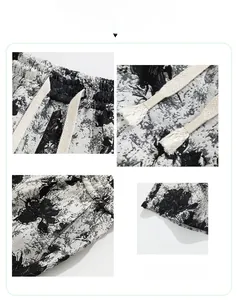 Detail view of summer shorts showing drawstring waistband and black floral ink print patterns