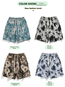 Detail view of printed beach shorts for men in blue, black lotus, and floral patterns