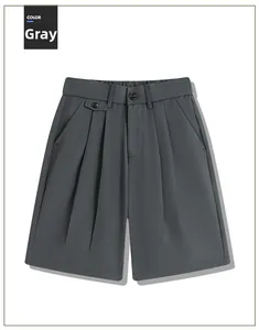 Macro detail of grey pleated suit shorts with high waist design and double button closure