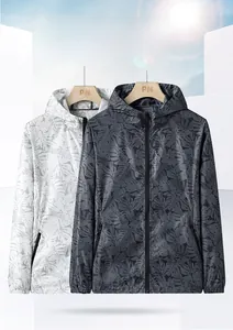 Detail of stretch sun protection jacket with tropical leaf print and hood zip closure