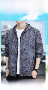 Detail of grey men's sun protection jacket with tropical leaf print and hood