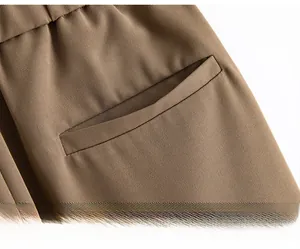 Detail of a large capacity side pocket and diagonal twill texture on khaki summer shorts