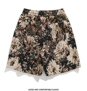 Detailed macro view of heavy floral jacquard fabric and elastic waist on men's beach shorts