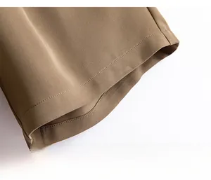 Detail view of khaki quick-dry shorts hem showing high-quality stitching and fabric texture