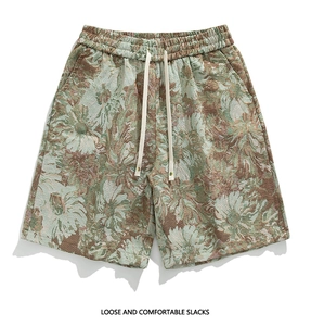 Detailed macro view of vintage floral jacquard fabric and drawstring on loose slacks