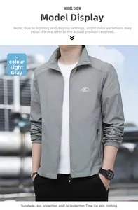 Close-up of light grey sun protection jacket with stand collar and mountain chest logo