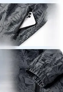 Detail of dark gray sun protection jacket showing zipper pocket and elastic windproof cuffs