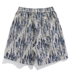 Detail view of elastic waistband and blue abstract pattern on cotton blend shorts