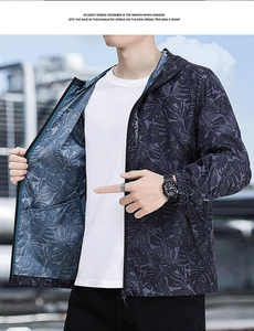 Detail of men's hooded sun protection jacket with grey tropical leaf patterns and zipper