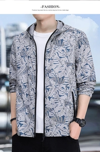 Detail of men's sun protection jacket featuring tropical leaf print and zipper pockets