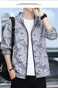 Detail of hooded men's sun protection jacket with tropical leaf print and elastic cuffs