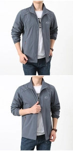 Detail of men's lightweight grey outdoor sun protection jacket with stand collar and chest logo