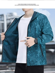 Detail of men's hooded sun protection jacket with tropical leaf print and full zipper