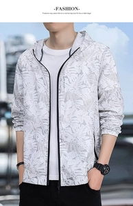 Detail of men's lightweight sun jacket featuring a hood and grey leaf print on white fabric