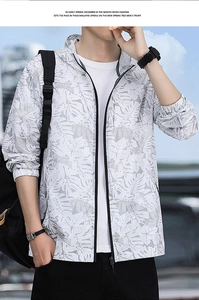 Detail of light gray sun protection jacket with palm leaf print and full zipper closure