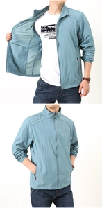 Detail view of light blue outdoor windbreaker with stand collar and sport logo