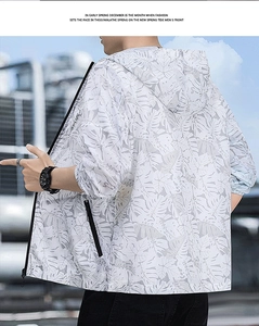 Detailed close-up of hooded sun protection jacket with grey palm leaf print