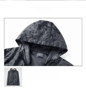 Detailed close-up of dark grey men's sun protection jacket with black leaf pattern