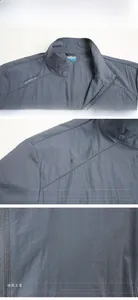 Detailed macro view of the stand-up collar and adventure spirit logo on a grey jacket