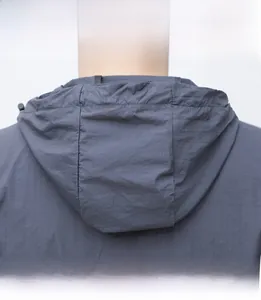 Detail view of the gray sun protection jacket hood with adjustable drawstrings and neck coverage