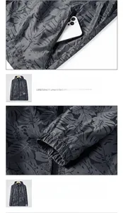 Detail of zippered side pocket and elasticized threaded cuffs on grey palm leaf jacket