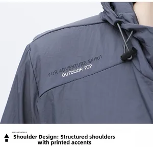 Macro detail of breathable outdoor jacket shoulder with adventure spirit text print
