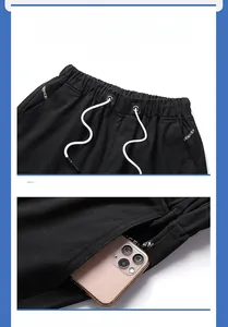 Detail of men's black shorts featuring elastic waist with drawstrings and side pockets