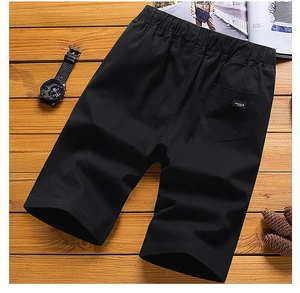 Flat lay of black breathable cotton shorts with an elastic waist and cargo back pocket