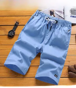 Detail of sky blue men's cotton shorts with elastic drawstring waist and side pockets