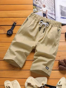 Men's breathable khaki cotton shorts with elastic drawstring waist on wooden floor