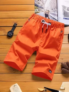 Men's bright orange cotton shorts with elastic drawstring waist and side letter tape detail